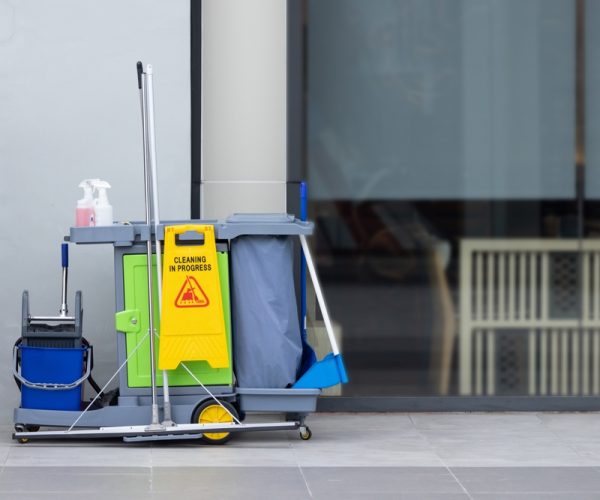 A,Cleaning,Cart,With,A,Yellow,Sign,On,It.,The